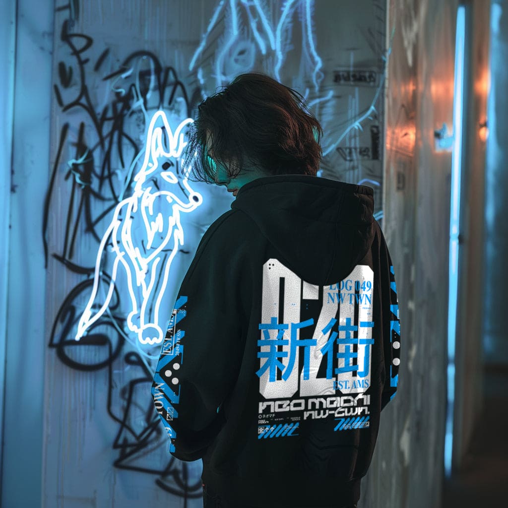 Person wearing a black hoodie with blue and white text, standing in front of a graffiti-covered wall with a neon wolf sign.