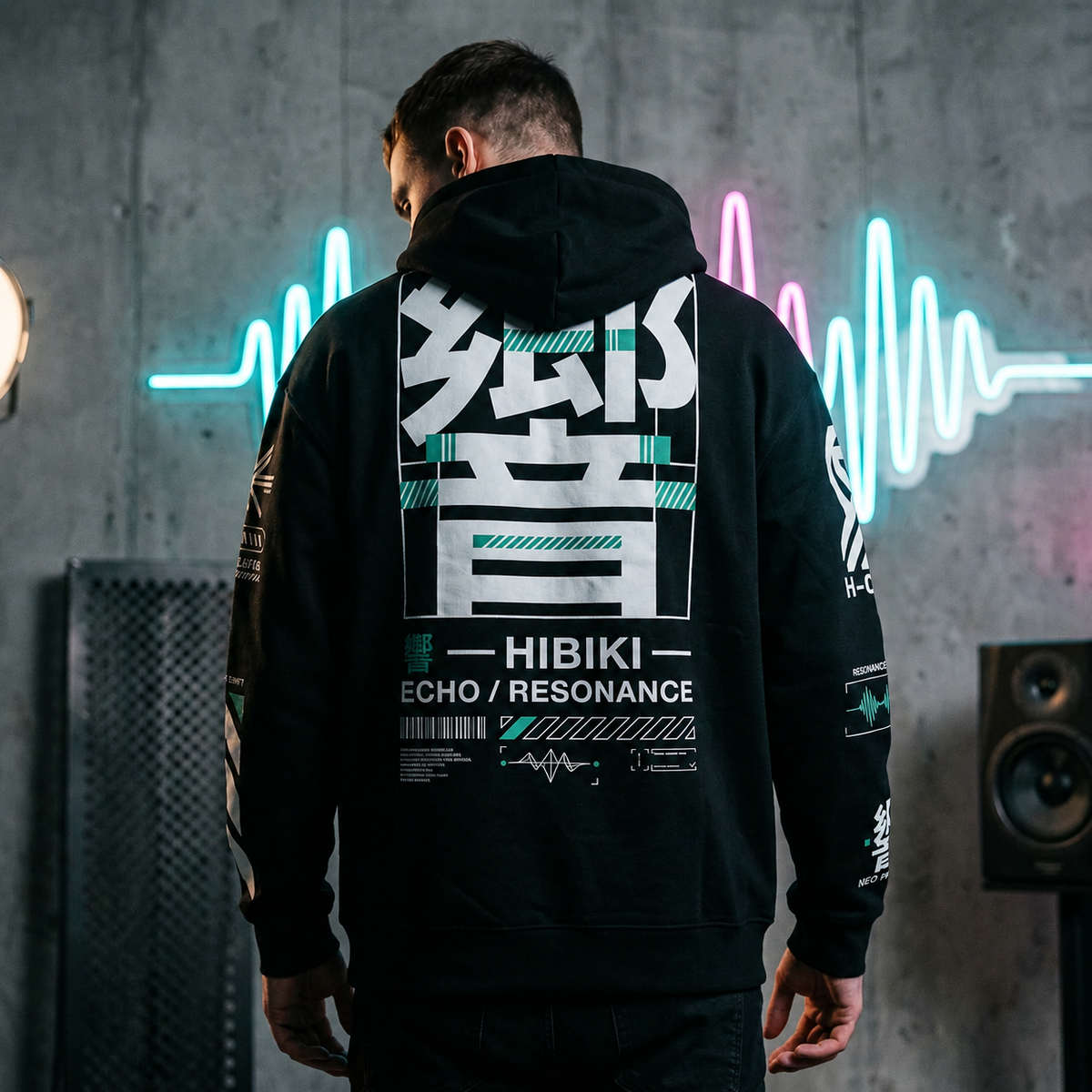 Person wearing a black hoodie with 'HIBIKI' branding in a neon-lit room.